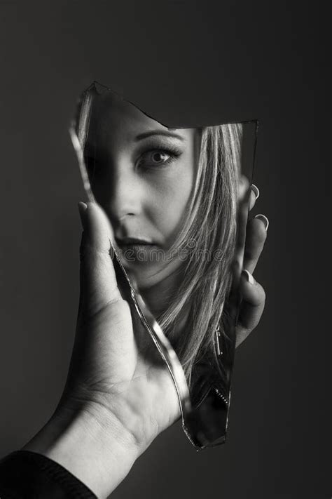 Woman Looking At Her Face In A Shard Of Broken Mirror Artistic C Stock