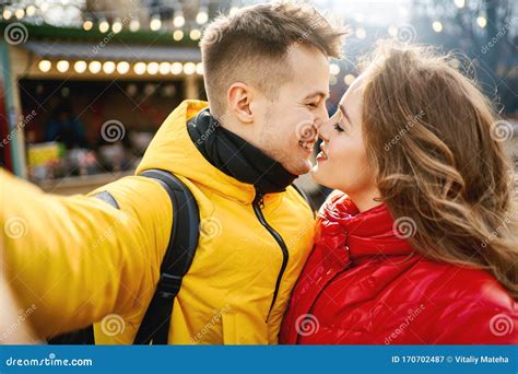 Young Romantic Couple In Love Making Selfie Smiling And Kissing