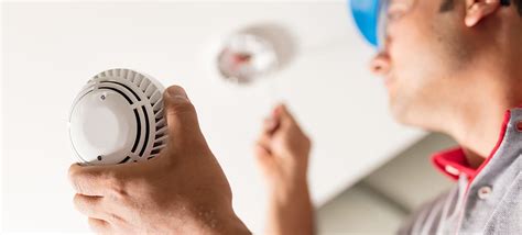 Man installing smoke detector