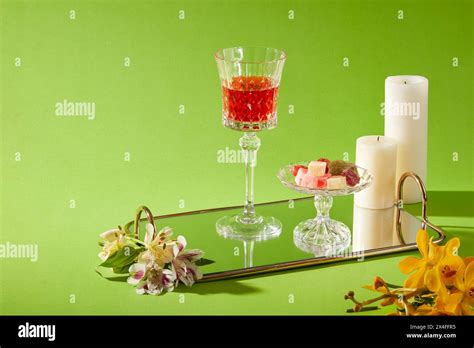 Front View Of Red Wine In Glass Displayed With Jam Tray And Candles On Mirror Sheet With Fresh