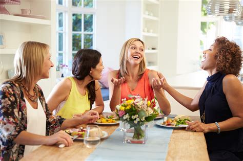 Mature Female Friends Sitting Around Table At Dinner Party Finess