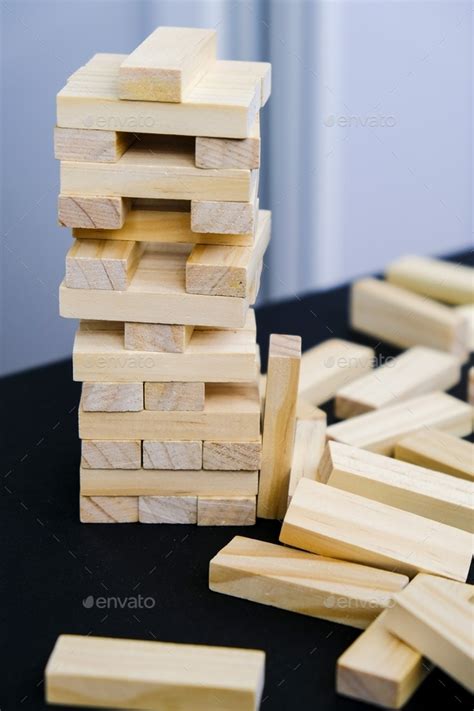 Building from wooden blocks. Game for family of wooden bars. Wood blocks stack game with Hand ...