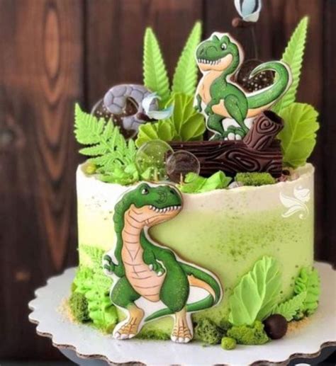 A Cake Decorated With Dinosaurs And Plants