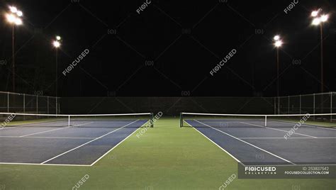 Tennis court at night in Seattle, Washington, USA — empty, chain link ...