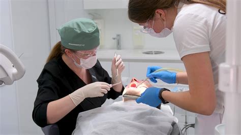 Woman Doctor Dentist Removes Man Patient Tooth Heavy Easy Extraction