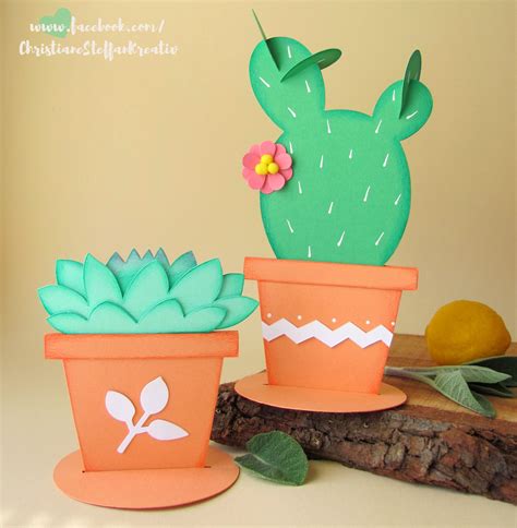 Two Paper Cactus Plant Pots Sitting Next To Each Other