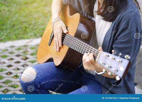 Women Playing Acoustic Guitar In The Garden Stock Photo Image Of