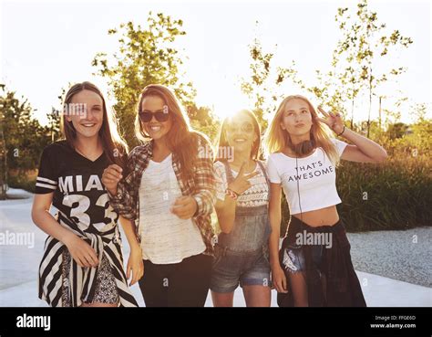 Group Of Girls Laughing And Posing Outside On A Summer Day Sun Flare