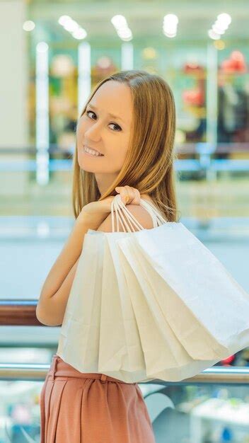 Premium Photo Women Carrying A Lot Of Shopping Bags In Blurred