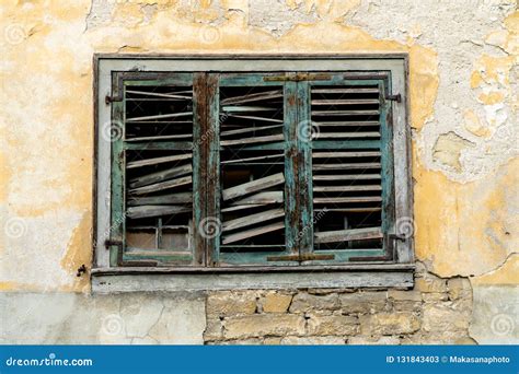 Old Broken Window Shutters On A Dilapidated And Run Down House Front