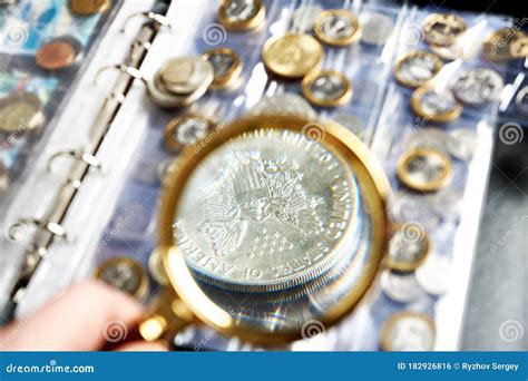 Numismatic Silver Dollar Coin With Magnifying Glass Stock Photo Image