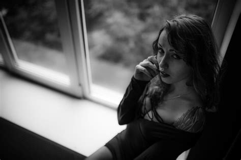 Premium Photo High Angle Portrait Of Sensuous Woman Sitting On Window