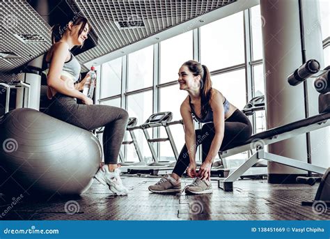 Sport Woman Sitting And Resting After Workout Or Exercise In Fitness