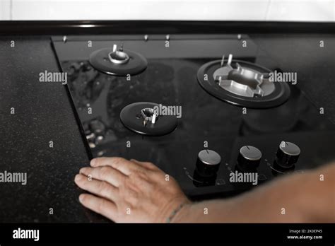 Installation Of A Gas Three Burner Built In Stove In A Black Countertop