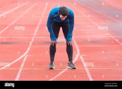 Athlete Young Man Tired Resting On Running Track Stock Photo Alamy