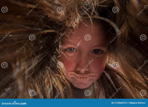 A Little Girl With Long Disheveled Hair Looks Like A Witch A Terrible