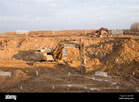 Excavators Working At Open Pit Mining Backhoe During Earthworks On