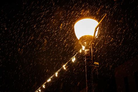 A street light in the rain at night photo – Free Brown Image on Unsplash