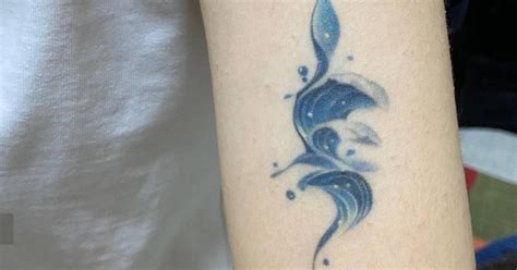 Abstract Wave Tattoo Located On The Upper Arm