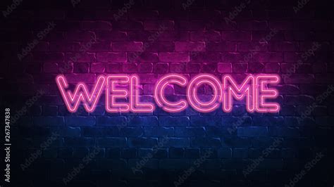 welcome neon sign. purple and blue glow. neon text. Brick wall lit by ...