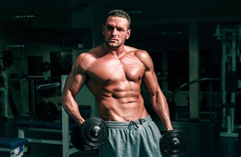 Premium Photo Bodybuilder Training In Gym With Dumbbells Sportsman