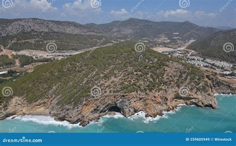 Aerial Shot Of A Cave Beach Surrounded By Mountains In The Port City Of