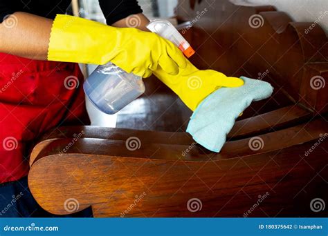 The Housekeepers Used Cloth And Cleaning Solution To Clean The Table