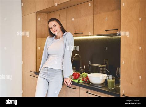 Beautiful Woman Leaning Against A Kitchen Counter Stock Photo Alamy