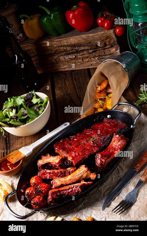 Grilled ribs in spicy marinade with salad and vegetables Stock Photo ...