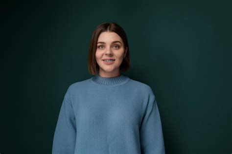 Premium Photo Woman Standing In Front Of Green Wall