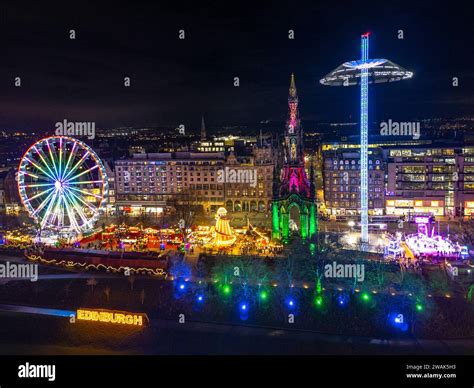 Night aerial view from drone of funfair rides in Edinburgh Christmas Market 2023 in Edinburgh ...