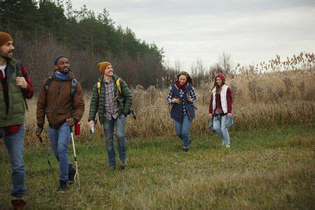 Group Of Friends On A Camping Or Hiking Trip In Autumn Day Men And