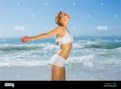 Gorgeous Fit Blonde Standing By The Sea With Arms Out Stock Photo Alamy