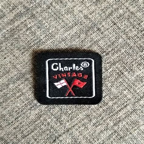 Black Base 50 GSM Custom Embroidered Woven Label For Garments Laser