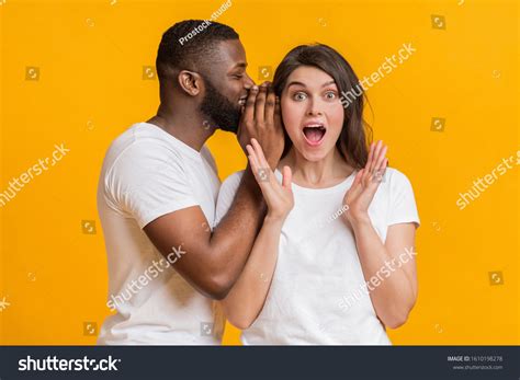 Man Whispering Into Woman S Ear Over 492 Royalty Free Licensable Stock