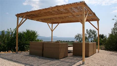 A Wooden Gazebo Sitting On Top Of A Gravel Field