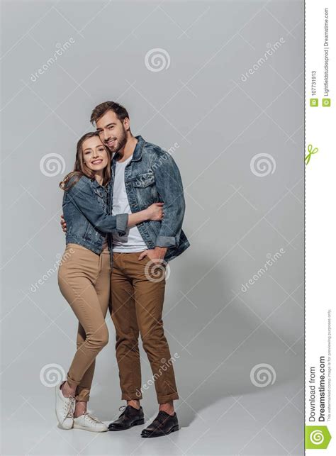 Full Length View Of Cheerful Young Couple Hugging And Smiling At Camera