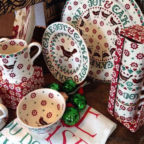 A Table Topped With Dishes And Cups Filled With Christmas Decorations