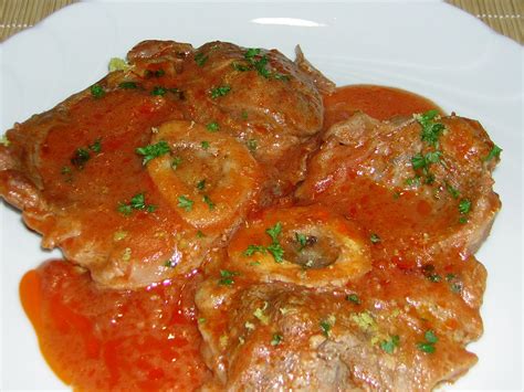 Meatballs Covered In Tomato Sauce On A White Plate