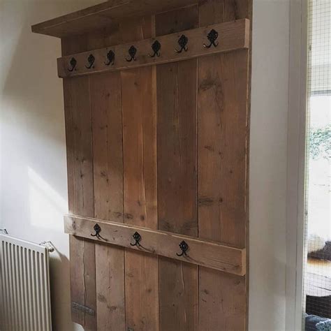 A Wooden Door With Hooks On It In A Room Next To A Radiator