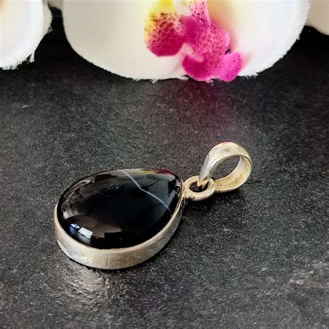 A Lovely Banded Black Onyx Teardrop Pendant Set In Sterling Silver The