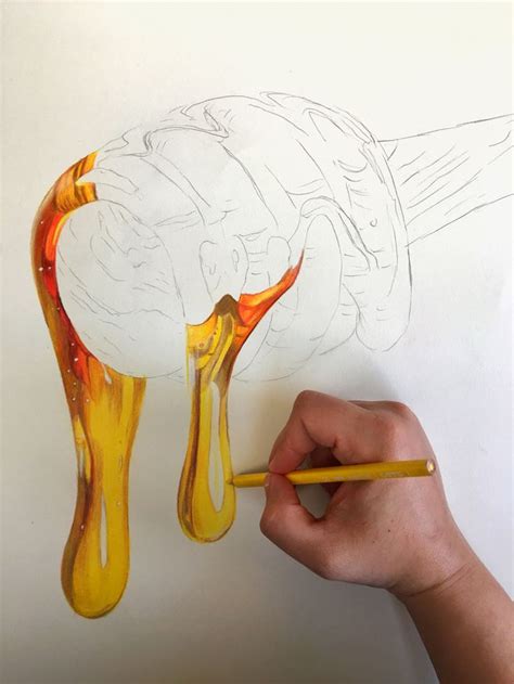 A Person Is Drawing Something With Colored Pencils On A Piece Of Paper