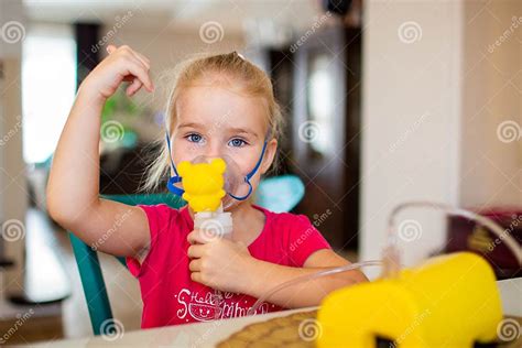 Little Girl With Allergic Asthma Using Inhaler And Showing Ok Looking