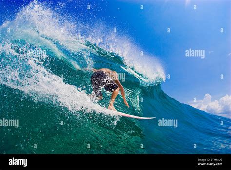 Surfer On A Surfboard Riding A Wave In The Ocean Sea Water Wave Beach Flipping And Doing Tricks