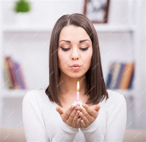 Premium Photo Beautiful Happy Girl Blows Out The Candle On A Birthday