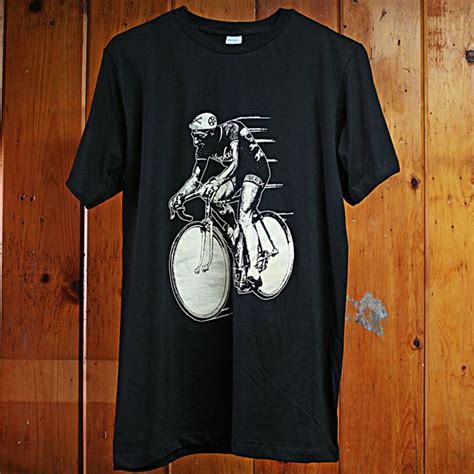 A Black T Shirt With A Man Riding A Bike On It