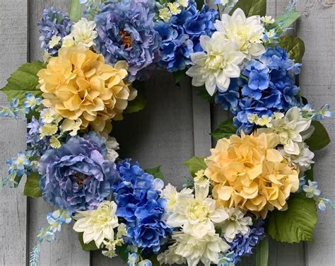 A Wreath With Blue Yellow And White Flowers