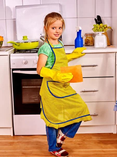 Children cleaning kitchen. — Stock Photo © poznyakov #32534063