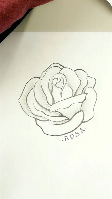 a drawing of a rose on top of a piece of paper