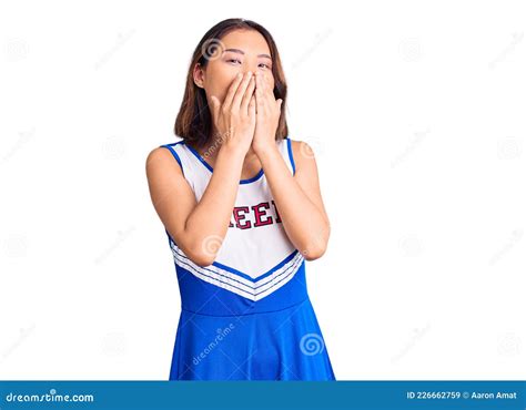 Young Beautiful Chinese Girl Wearing Cheerleader Uniform Laughing And